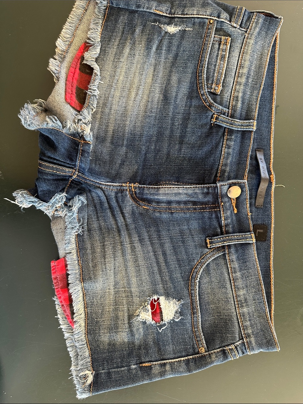 Distressed Blue Denim Women’s Shorts with Red Plaid Accents